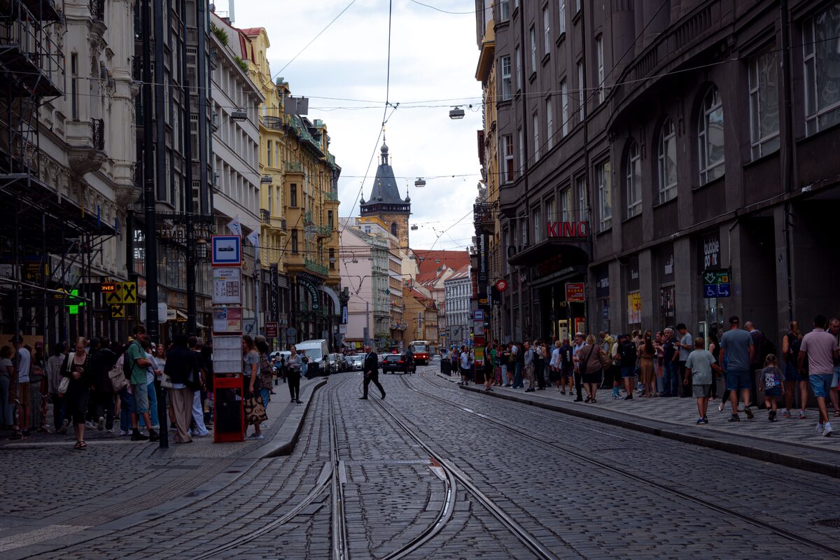 Explore the bustling streets of Prague with tram lines and historic architecture in this urban snapshot.