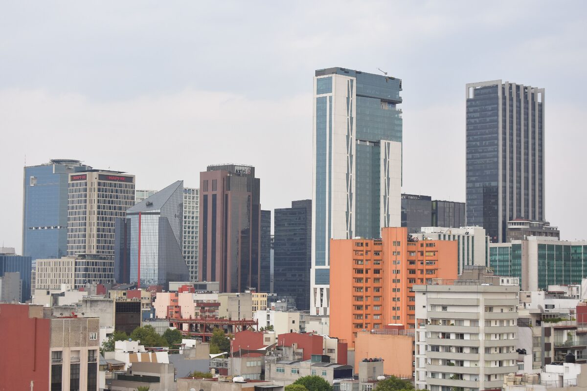 A striking cityscape showcasing modern skyscrapers against a cloudy sky.