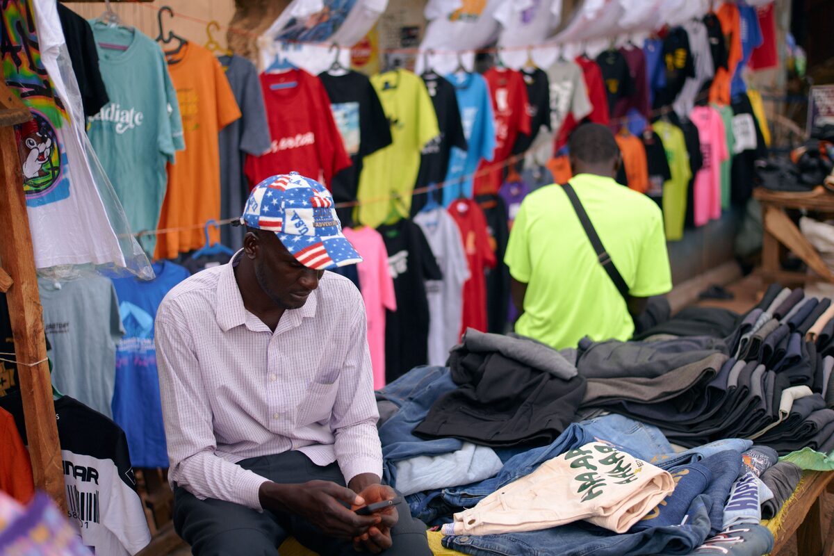 Explore the colorful evening market in Jos, Nigeria, featuring vibrant clothes and local sellers.