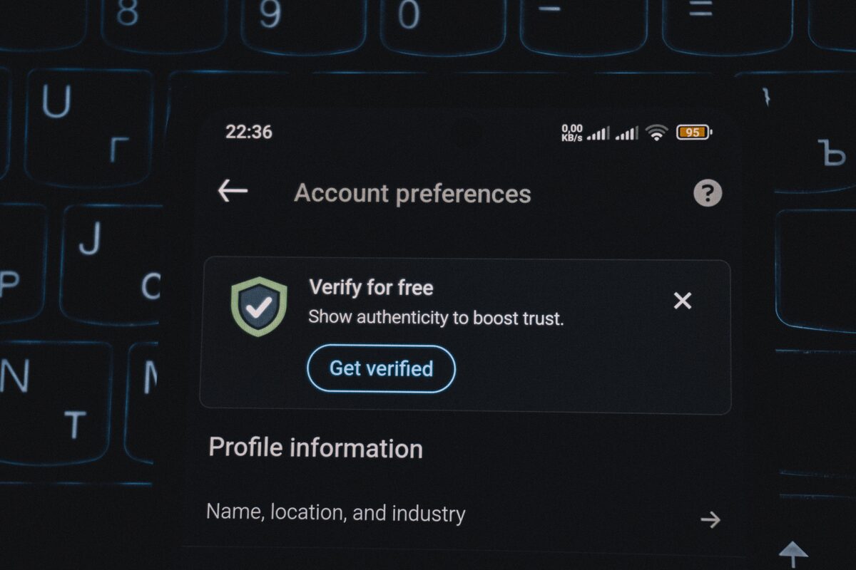 Close-up of a smartphone screen displaying account verification alert. Ideal for security and authenticity themes.