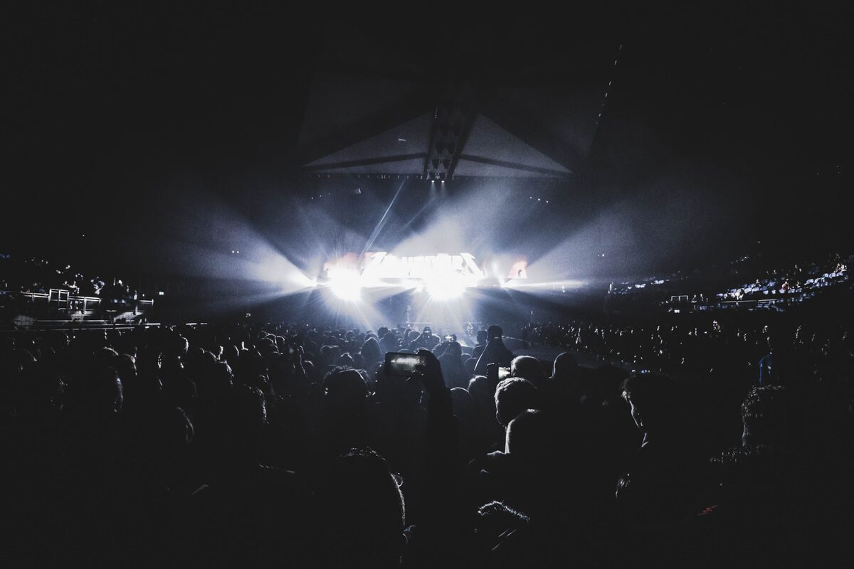 Dynamic concert scene with an energetic crowd at night in a London stadium.