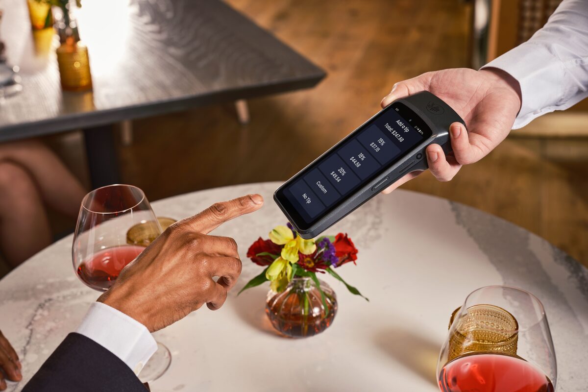 Elegant fine dining setting with a digital point of sale system for seamless payment and tipping.